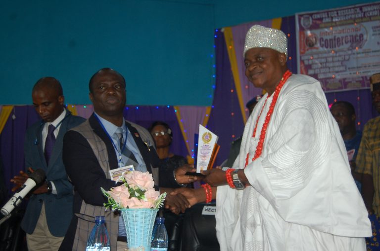 The Rector Dr. Dayo Oladebeye presenting an award to the royal Guest of Honour Oba (Dr.) Francis Adefarakanmi Agbede the Olowa of Igbara-Oke Kingdom.